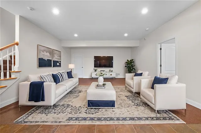 a living room with furniture and a flat screen tv