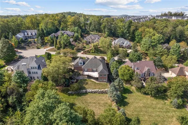 an aerial view of house with yard and mountain view in back
