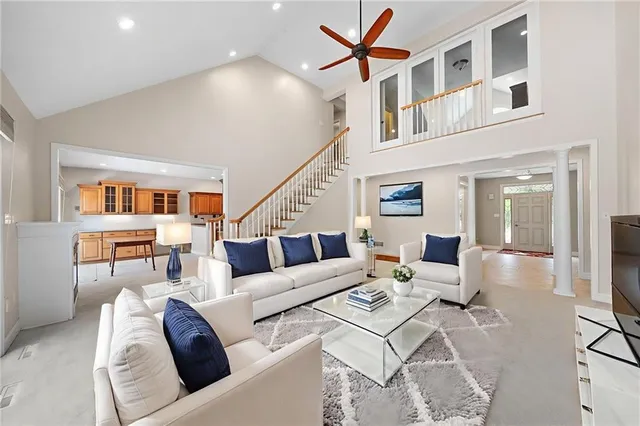 a living room with furniture and a ceiling fan