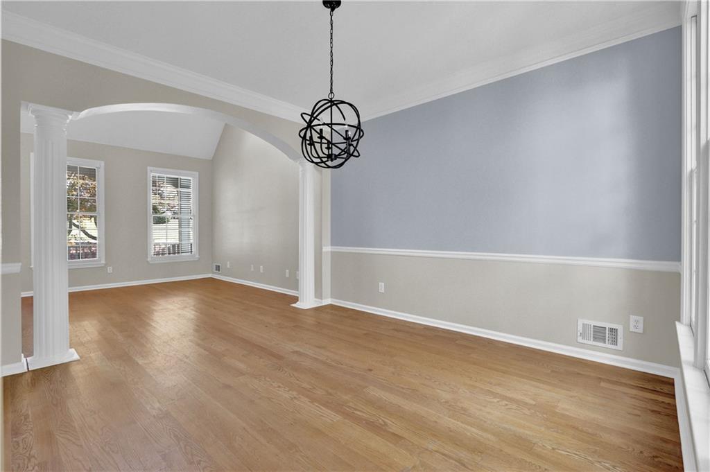 1872 Bakers Mill Road Dacula, GA 30019 - Photo 11 of 47 a view of an empty room with wooden floor and windows