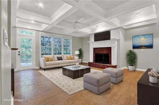 a living room with furniture wooden floor and a large window