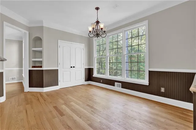 a view of a room with a cabinet and wooden floor