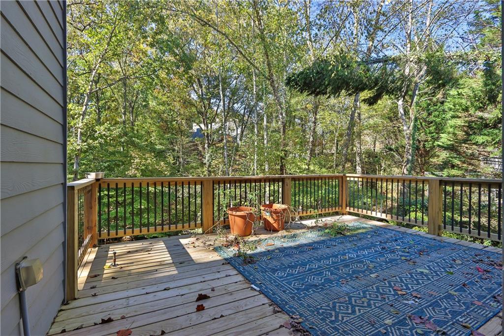 1872 Bakers Mill Road Dacula, GA 30019 - Photo 24 of 47 a view of a deck with two chairs and wooden floor