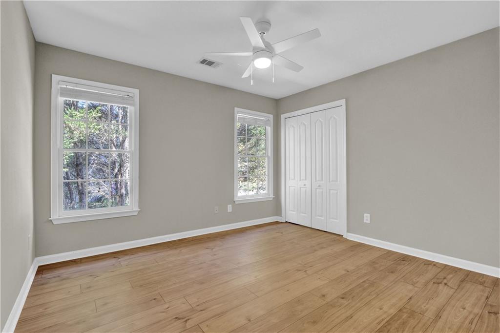 1872 Bakers Mill Road Dacula, GA 30019 - Photo 25 of 47 a view of an empty room with a window and wooden floor