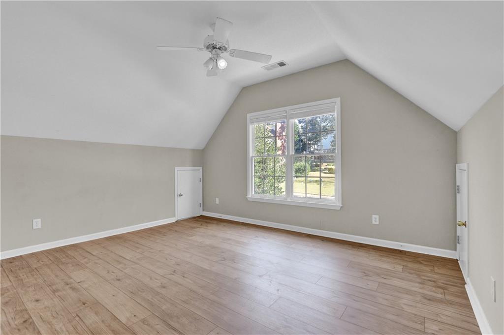 1872 Bakers Mill Road Dacula, GA 30019 - Photo 26 of 47 an empty room with wooden floor and windows