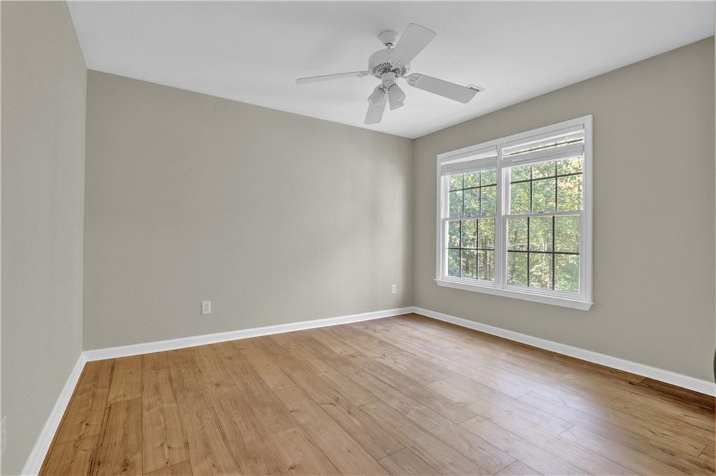 1872 Bakers Mill Road Dacula, GA 30019 - Photo 29 of 47 a view of an empty room with a window and wooden floor