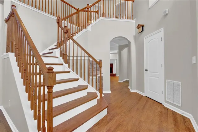 a view of entryway and hall with wooden floor