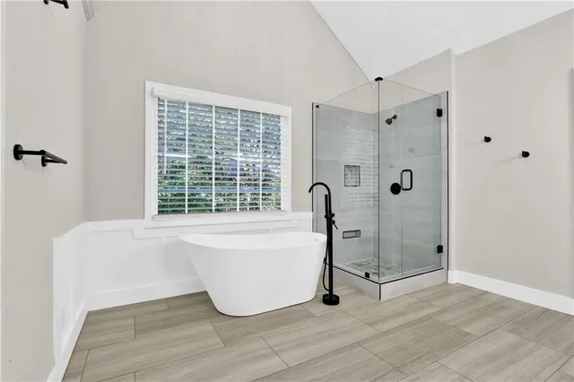 a bathroom with a tub and shower