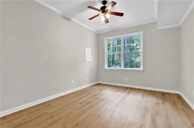 wooden floor in an empty room with a window