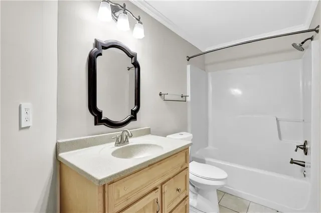 a bathroom with a sink toilet and a mirror