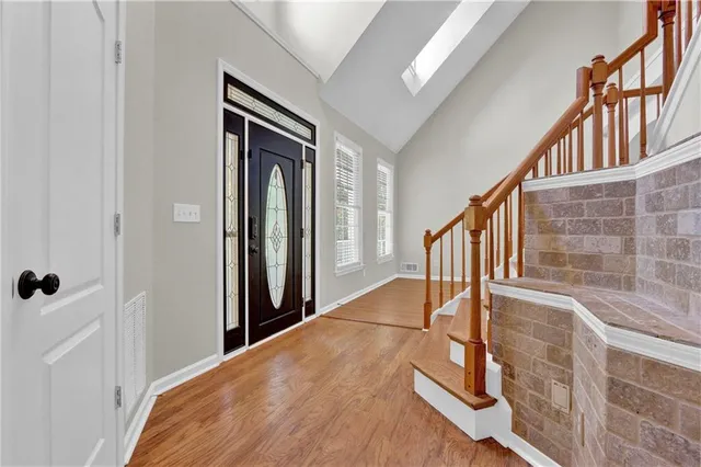 a view of staircase with lots of frames on wall and a window