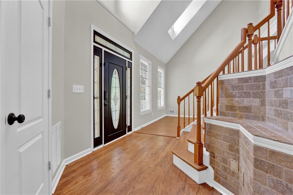 1872 Bakers Mill Road Dacula, GA 30019 - Photo 4 of 47 a view of staircase with lots of frames on wall and a window