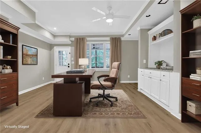 a view of a workspace with furniture and a window