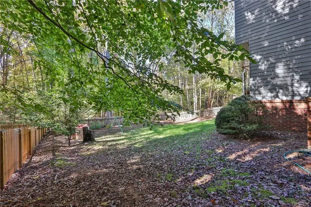 a view of a backyard with large trees