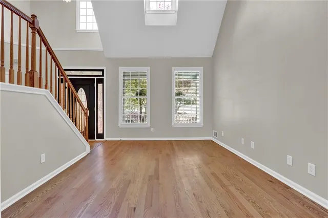 wooden floor in an empty room with a window
