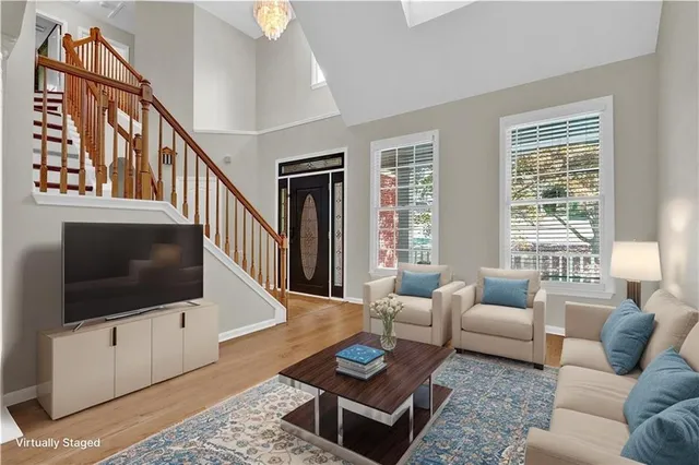 a living room with furniture a rug and a flat screen tv