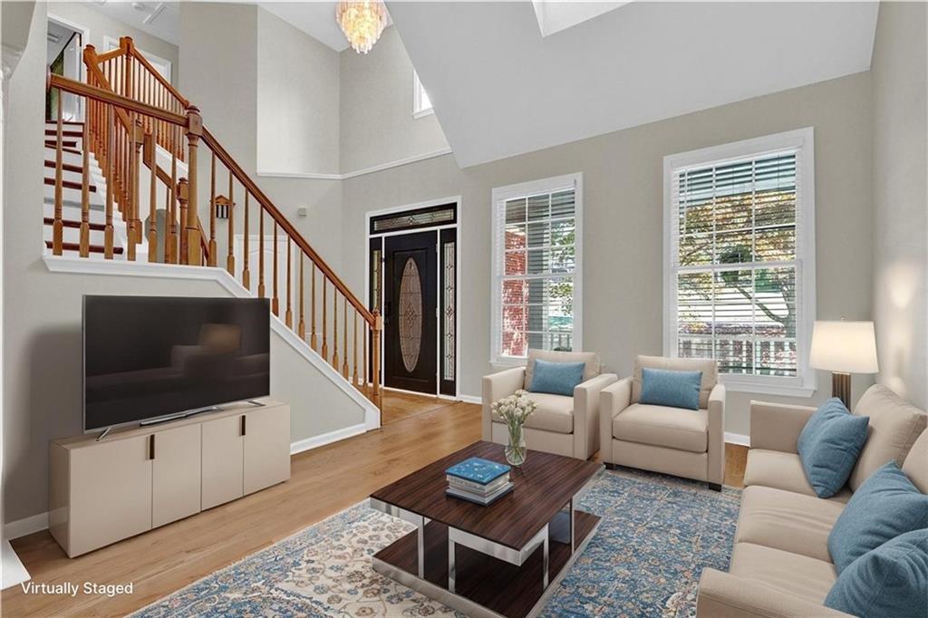 1872 Bakers Mill Road Dacula, GA 30019 - Photo 7 of 47 a living room with furniture a rug and a flat screen tv