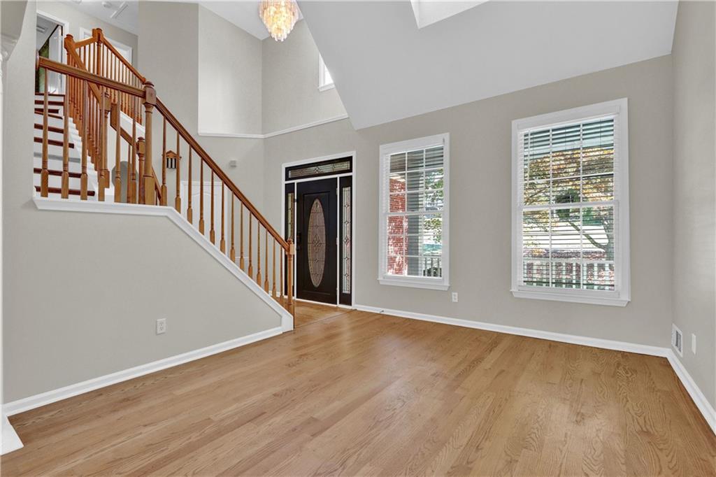 1872 Bakers Mill Road Dacula, GA 30019 - Photo 8 of 47 a view of an empty room with wooden floor and a window