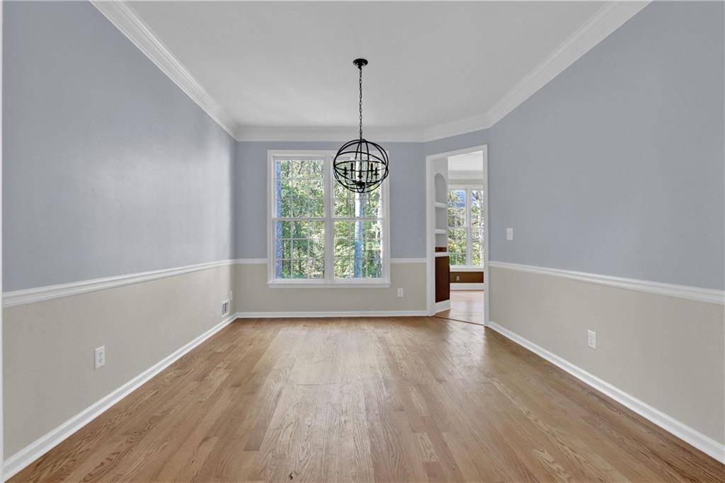 1872 Bakers Mill Road Dacula, GA 30019 - Photo 9 of 47 a view of an empty room with window and wooden floor