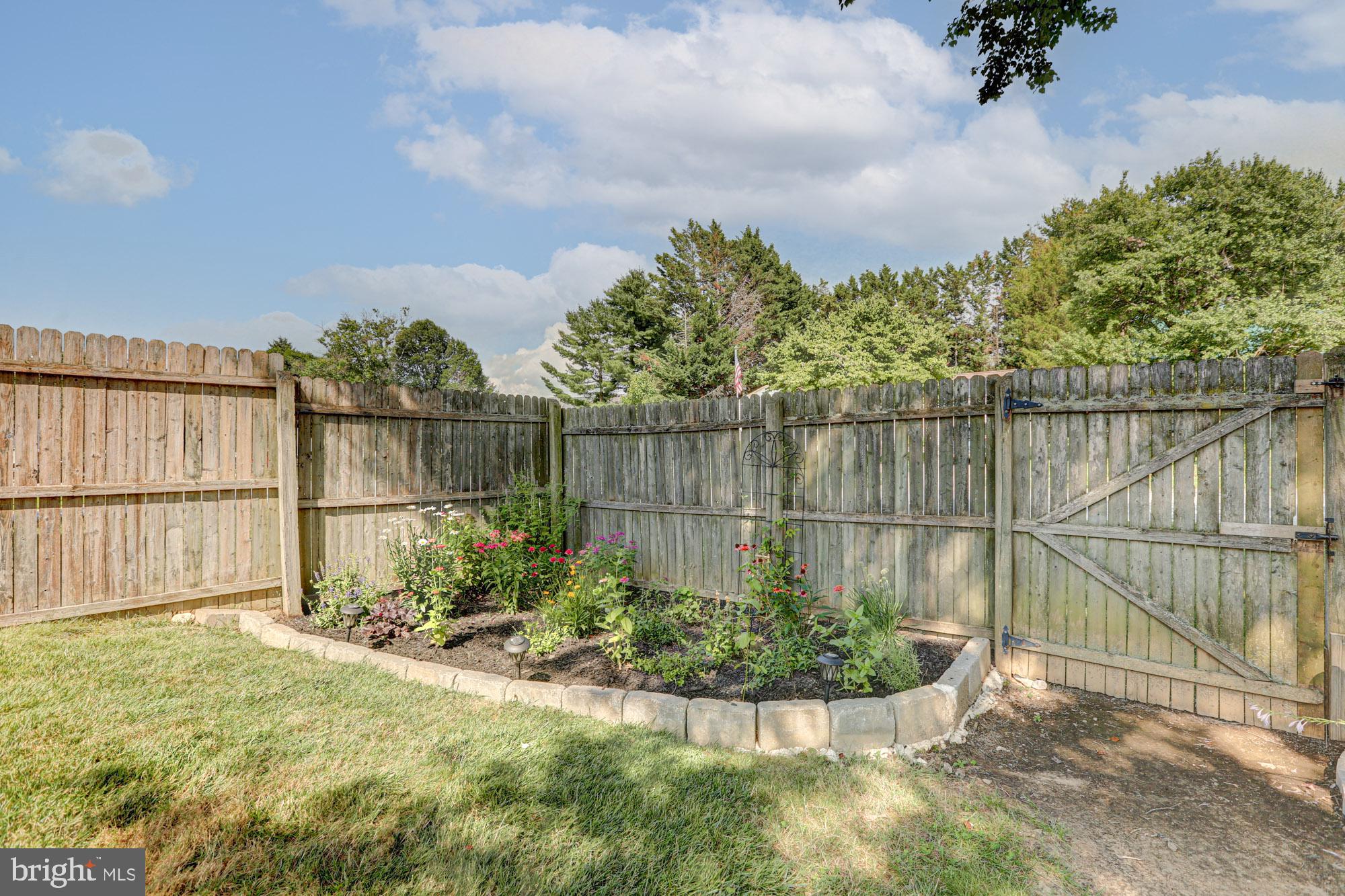 6 3 Rivers Drive Newark, DE 19702 - Photo 11 of 63 Charming garden oasis behind wooden fence.