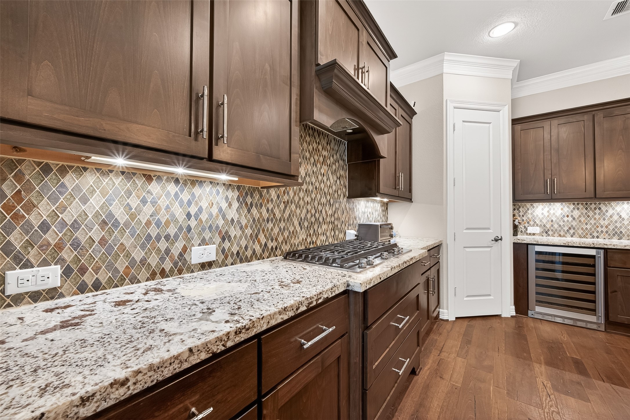 32607 Wingfoot Circle Fulshear, TX 77441 - Photo 18 of 39 This kitchen features many designer touches including the gorgeous backsplash and beautiful cabinetry.