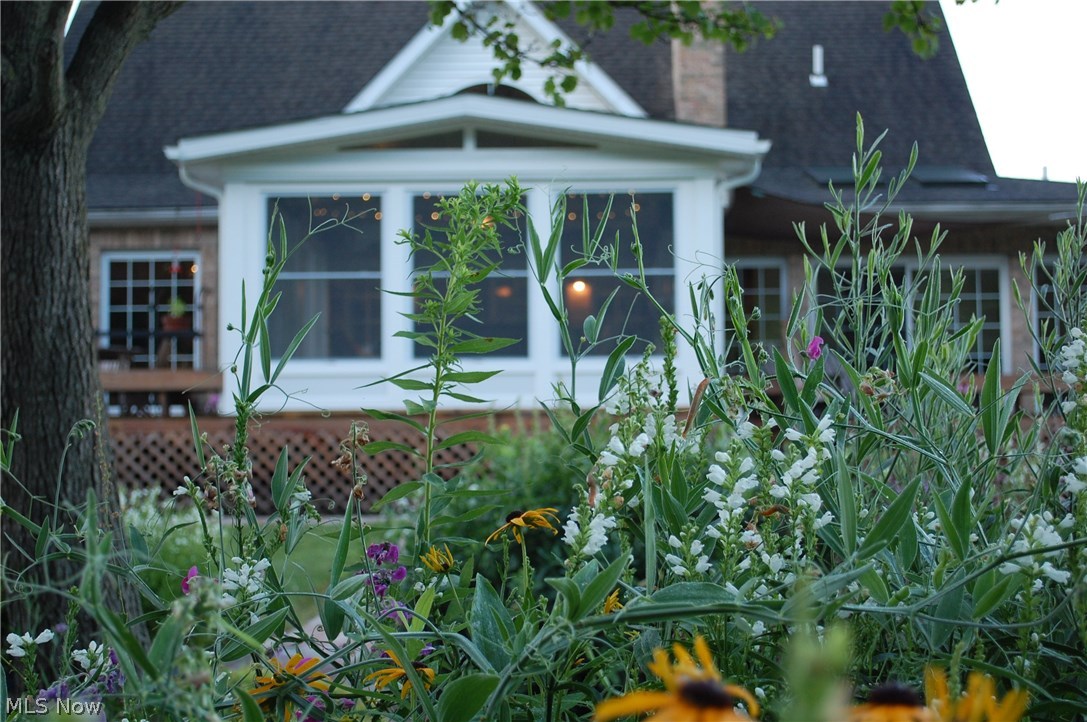 17580 Huntley Road Windsor, OH 44099 - Photo 30 of 35 Summer brings a profusion of blooms in the perennial beds....Irrigation run to all perennial beds and water and electric run to pergola with drip irrigation installed for hanging baskets under pergola.