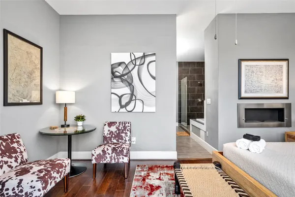 a bedroom with furniture and a wooden floor