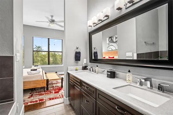 a bathroom with double vanity and a mirror