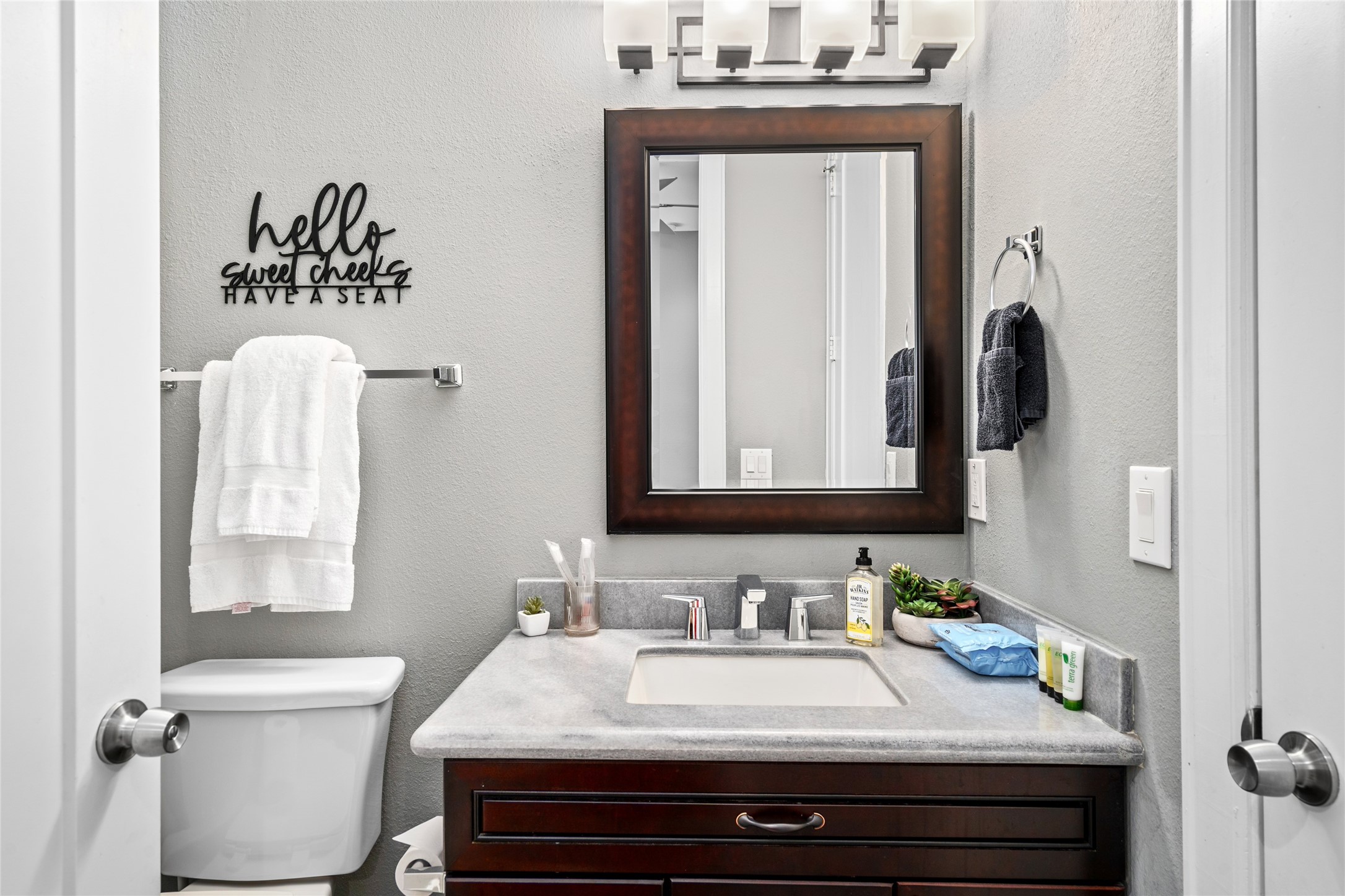 2104 Webster Street Houston, TX 77003 - Photo 22 of 30 a bathroom with a granite countertop sink and a mirror