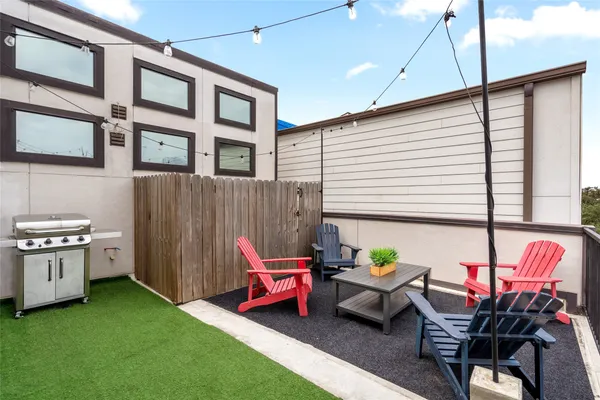 a backyard of a house with outdoor seating