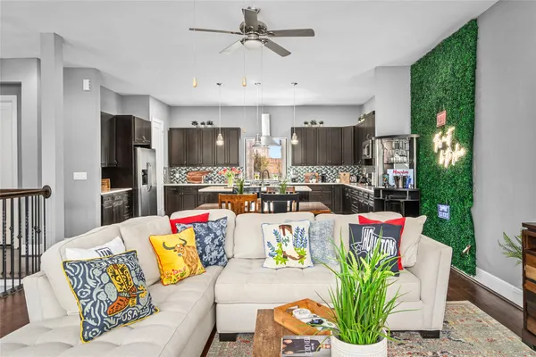 a living room with stainless steel appliances kitchen island granite countertop furniture and a view of kitchen