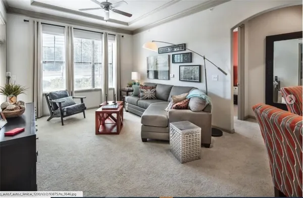 a living room with furniture and a large window