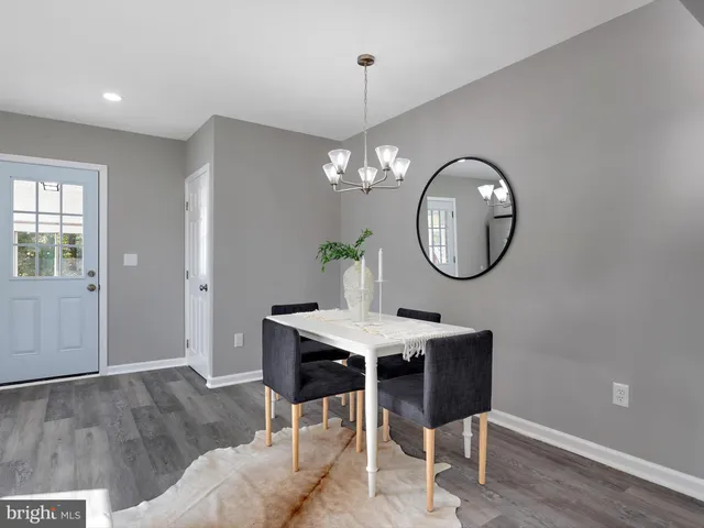 a view of a dining room with a table and chairs