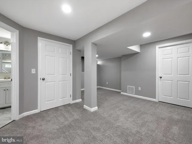 an empty room with windows and closet