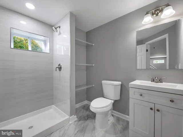 a bathroom with a toilet sink and shower