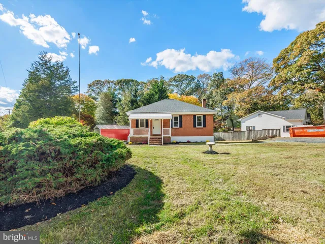 a view of a house with a yard and hanging chair