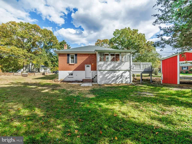 a front view of house with yard and trees