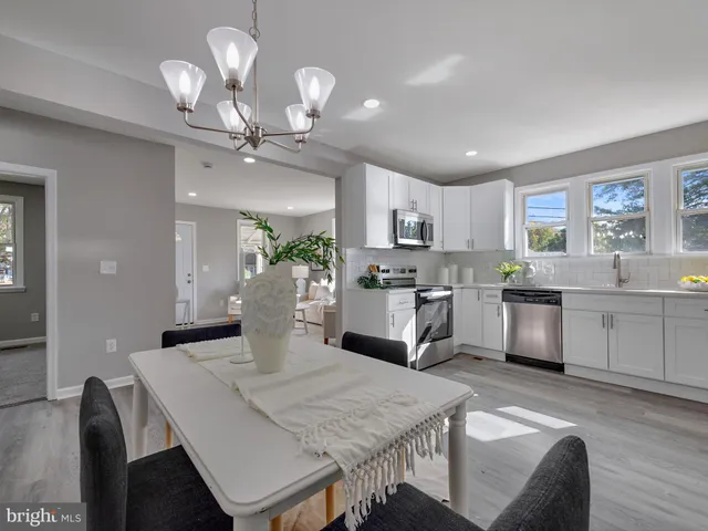 a kitchen with granite countertop kitchen island white cabinets and stainless steel appliances