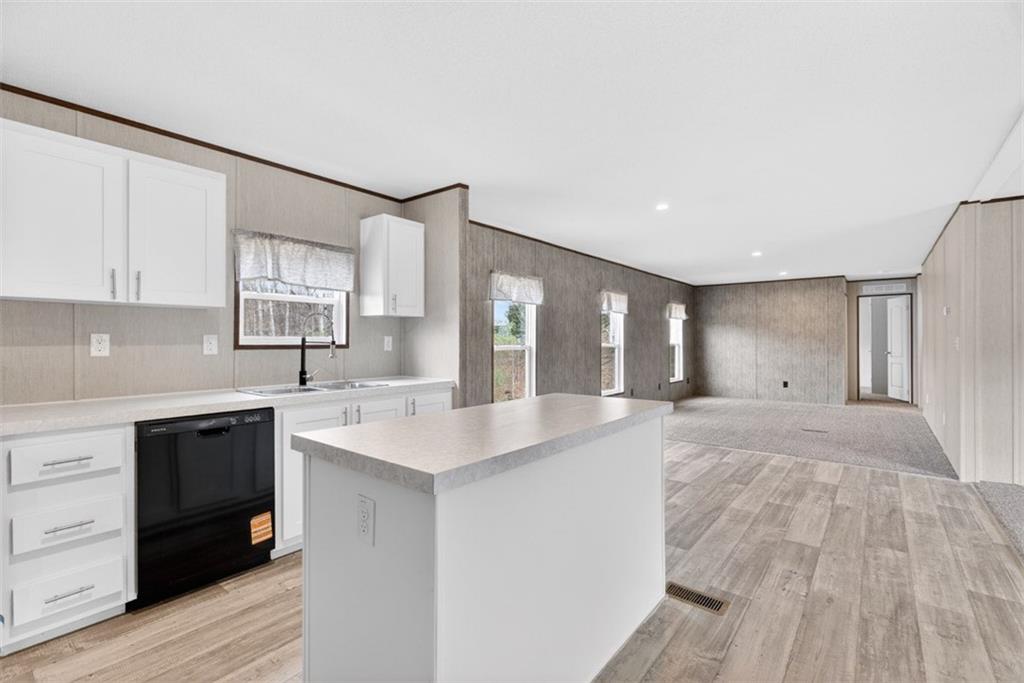 533 Pearwood Road Royston, GA 30662 - Photo 11 of 50 a large white kitchen with wooden floor and a sink