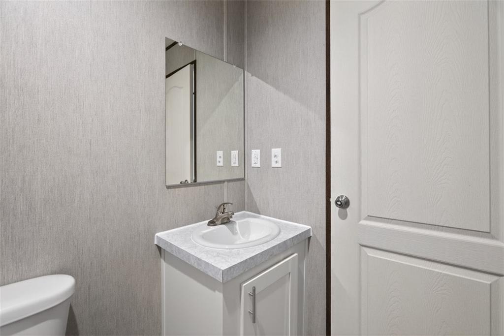 533 Pearwood Road Royston, GA 30662 - Photo 35 of 50 a bathroom with a sink a toilet and a mirror