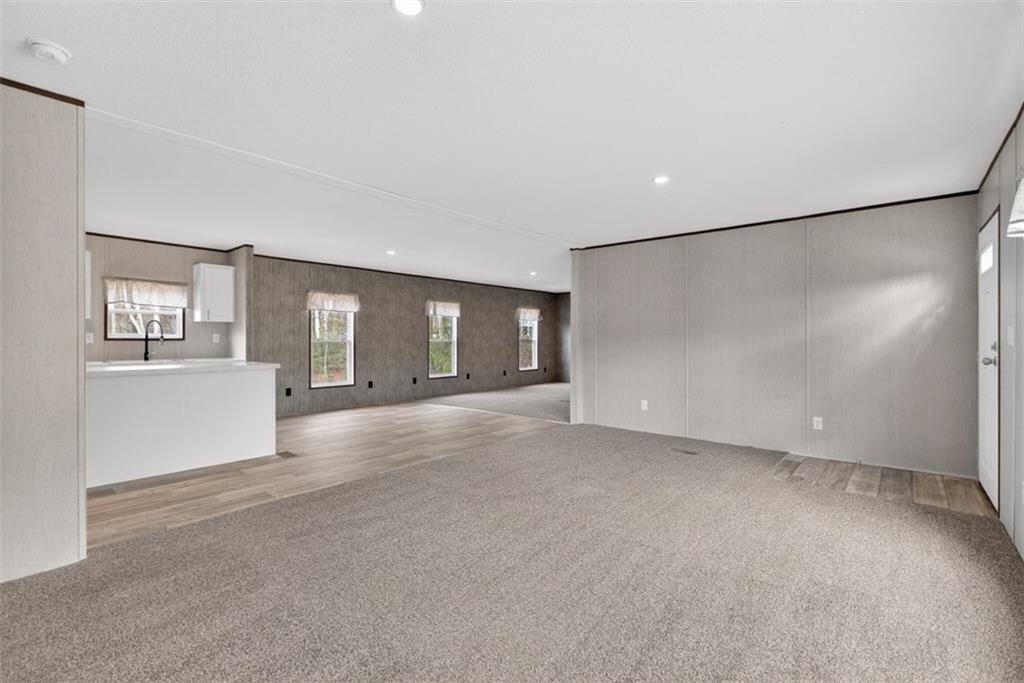 533 Pearwood Road Royston, GA 30662 - Photo 5 of 50 a view of a big room with windows and chandelier fan