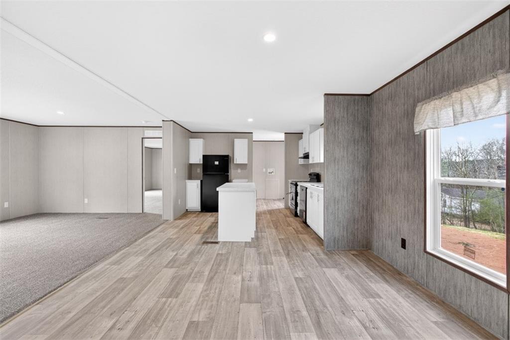 533 Pearwood Road Royston, GA 30662 - Photo 9 of 50 a view of a kitchen with wooden floor and a large window