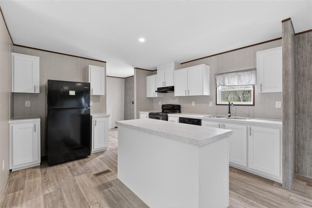533 Pearwood Road Royston, GA 30662 - Photo 10 of 50 a kitchen with a refrigerator sink and cabinets