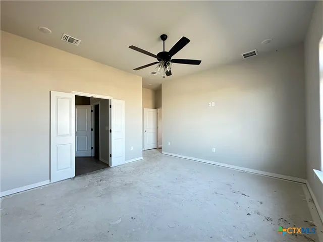 a view of a livingroom with a ceiling fan and window