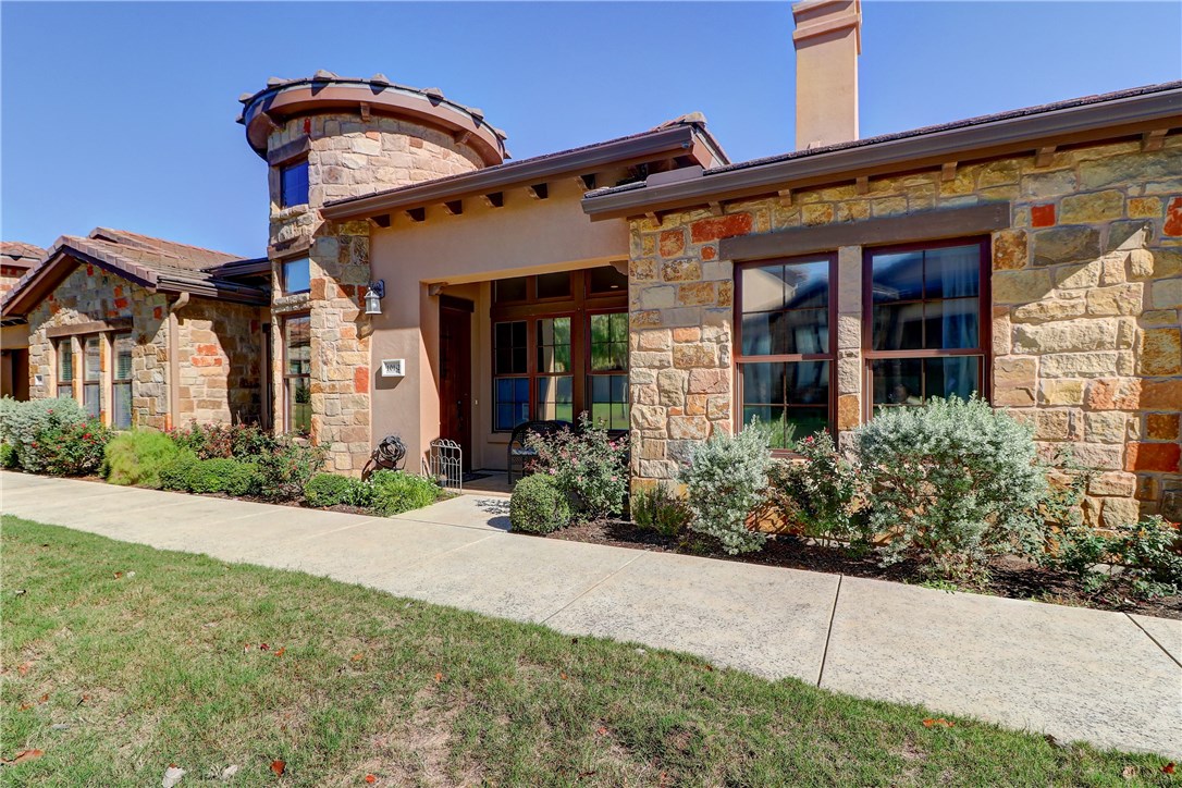 101 Rivalto Circle, Unit 2 Lakeway, TX 78734 - Photo 1 of 1 front view of a house with a small yard
