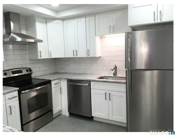 a kitchen with a stove refrigerator and microwave