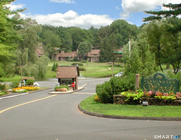 a view of a street with houses on both side of the road
