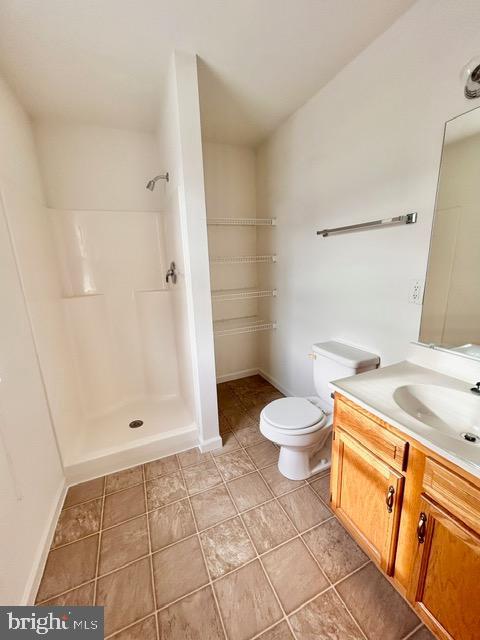 2005 Greystone Drive Lebanon, PA 17042 - Photo 25 of 35 a bathroom with a granite countertop toilet a sink and a shower