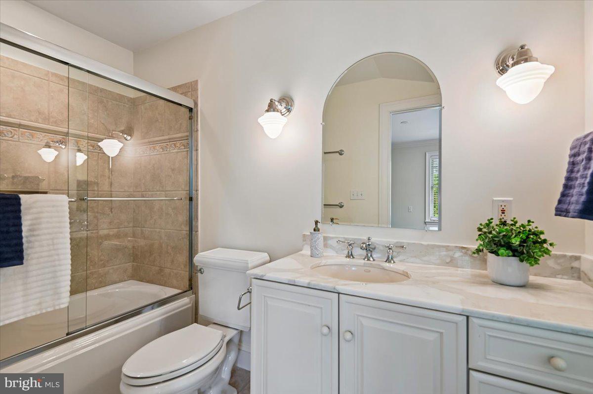 2700 Falling Timber Trail Edgewater, MD 21037 - Photo 45 of 89 a bathroom with a granite countertop sink a toilet a mirror and shower