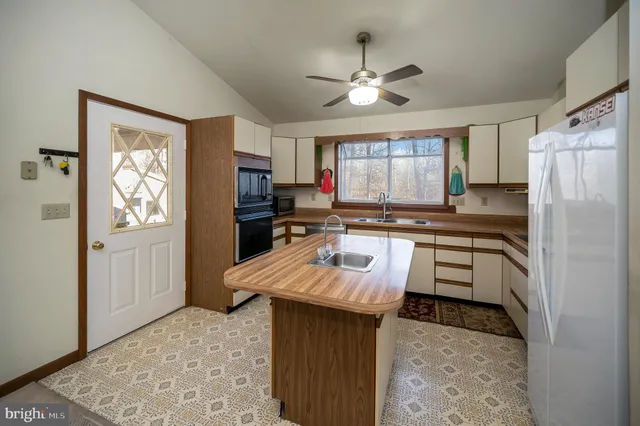 a kitchen with a refrigerator stove and sink